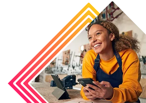 Women leaning over counter with her cell phone